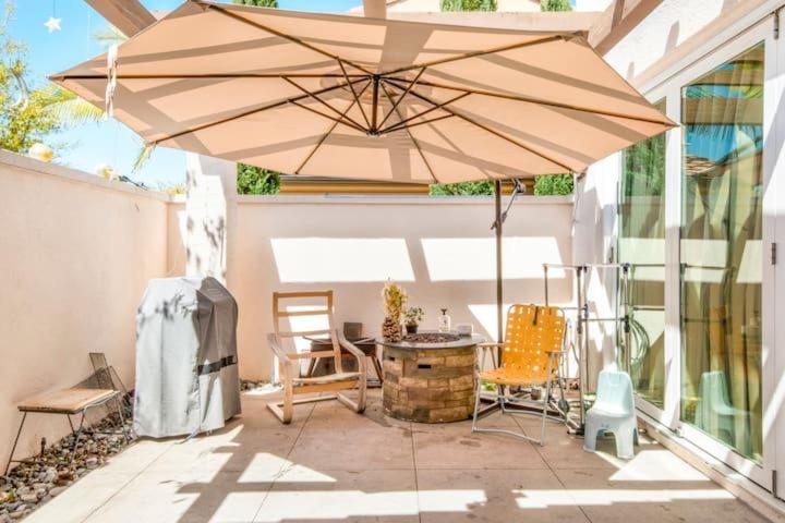 a patio with a table and an umbrella at FB Master in Irvine
