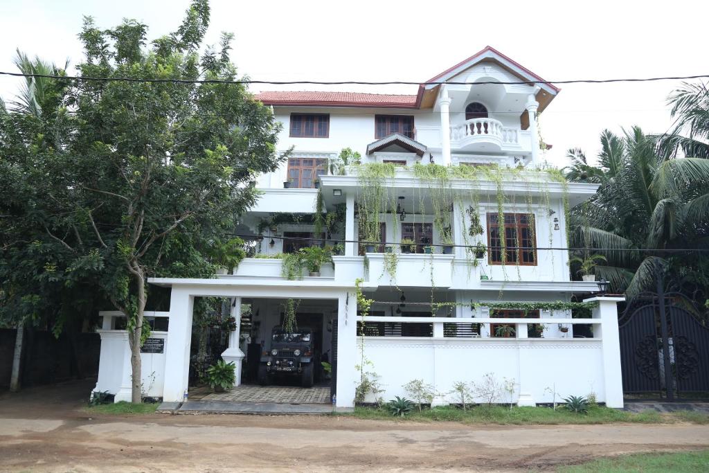 a white house with a white garage at Munril Guest in Jaffna