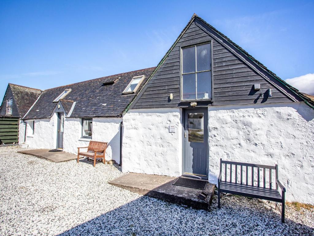 a building with a bench in front of it at Beinn Uidhe Studio Apartment - Uk49100 in Inchnadamph