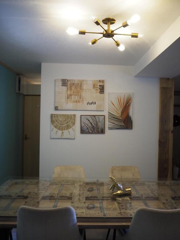 a dining room table with chairs and a ceiling fan at Gaju Camp in Wakayama