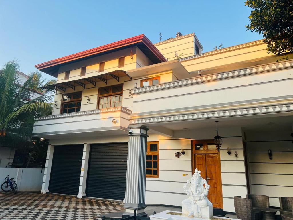 a house with a white statue in front of it at Alps Villa in Jaffna