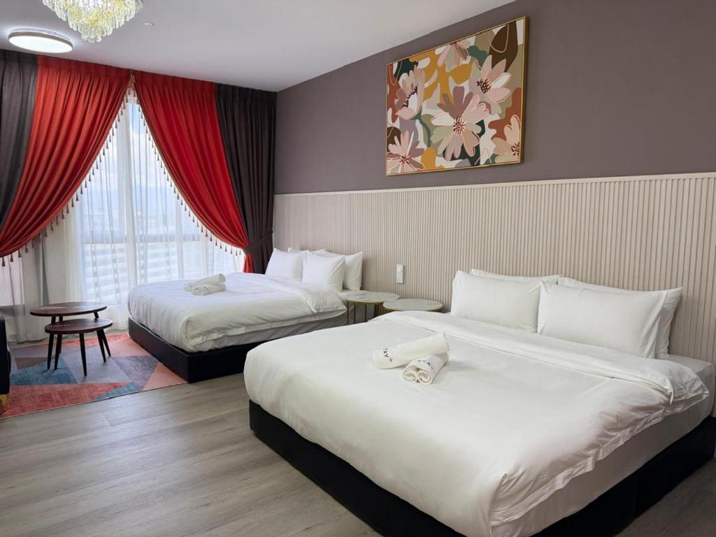 a hotel room with two beds and a window at Inap II, Suterabay By Ayuhouz in Kota Kinabalu
