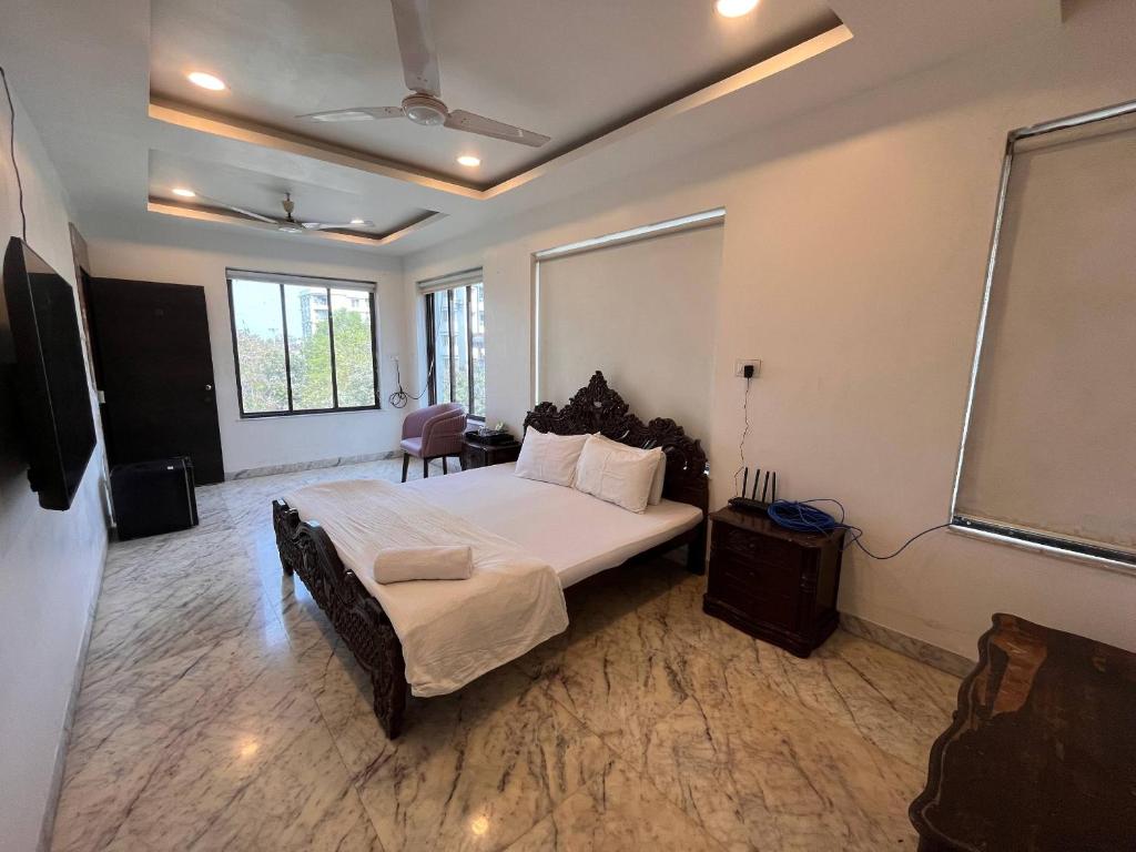 a bedroom with a large bed and a large window at Urban Nest in Nagpur