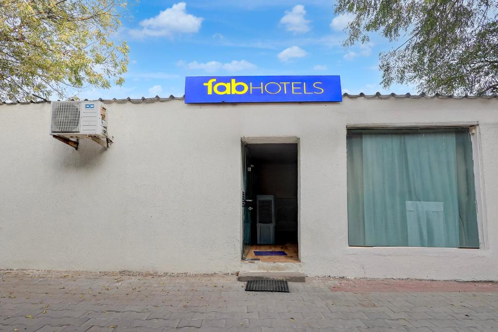a building with a sign that reads tab baths at FabHotel Aavkar in Sātej