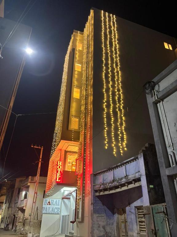 a tall building with christmas lights on it at night at Hotel Barai Palace in Dwarka