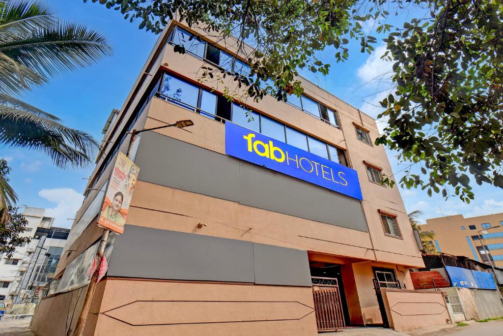 a building with a toko hotels sign on it at FabHotel Dream Sky in Kharadi