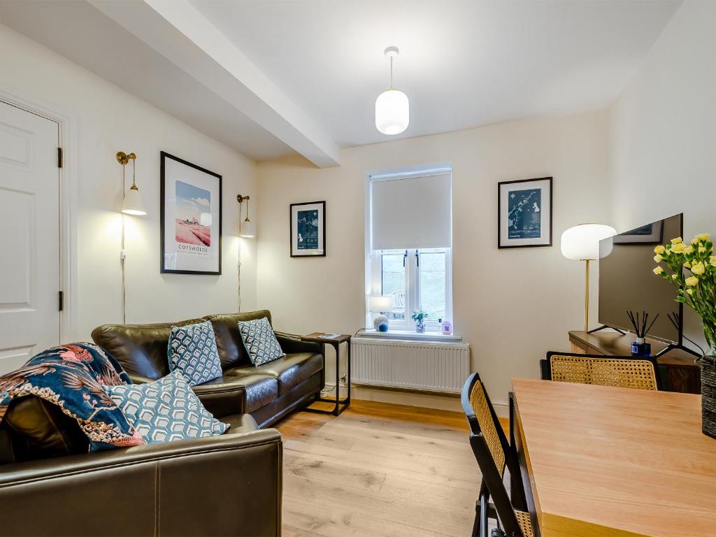 a living room with a couch and a table at The Colleys in Lechlade