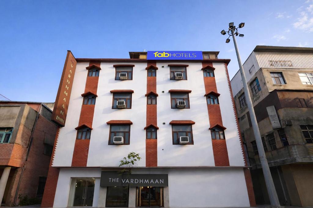 a tall building with a sign on top of it at FabHotel Vardhmaan Inn in New Delhi