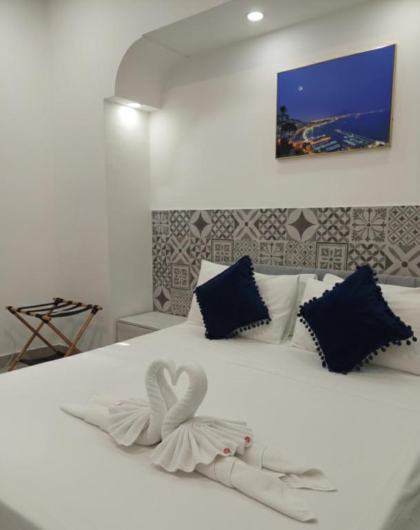 a white bed with a heart made out of towels at Capodimonte Home in Naples