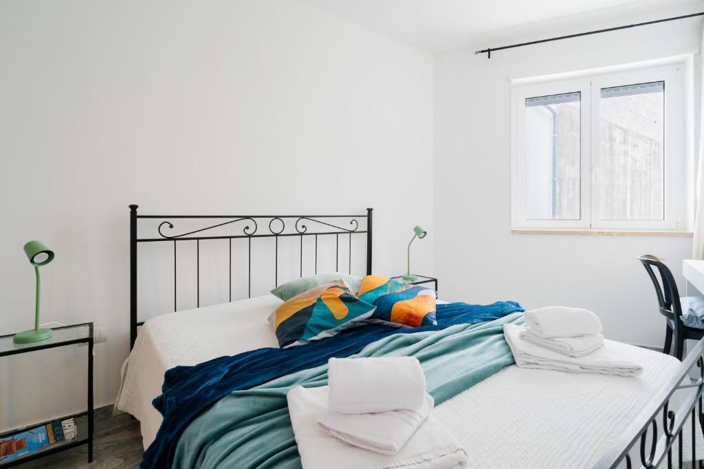 a bedroom with a bed with towels on it at Kalès home in Otranto in Otranto