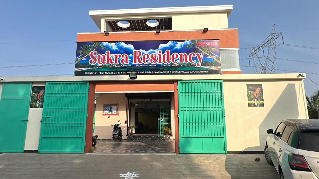 a building with a sign for a sizzler restaurant at Sukra Residency in Valavanūr