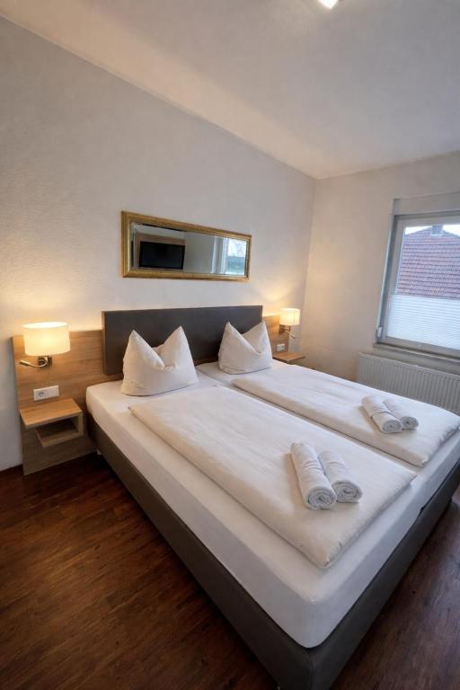 a large white bed in a room with a window at Tilla's Hof in Hamm
