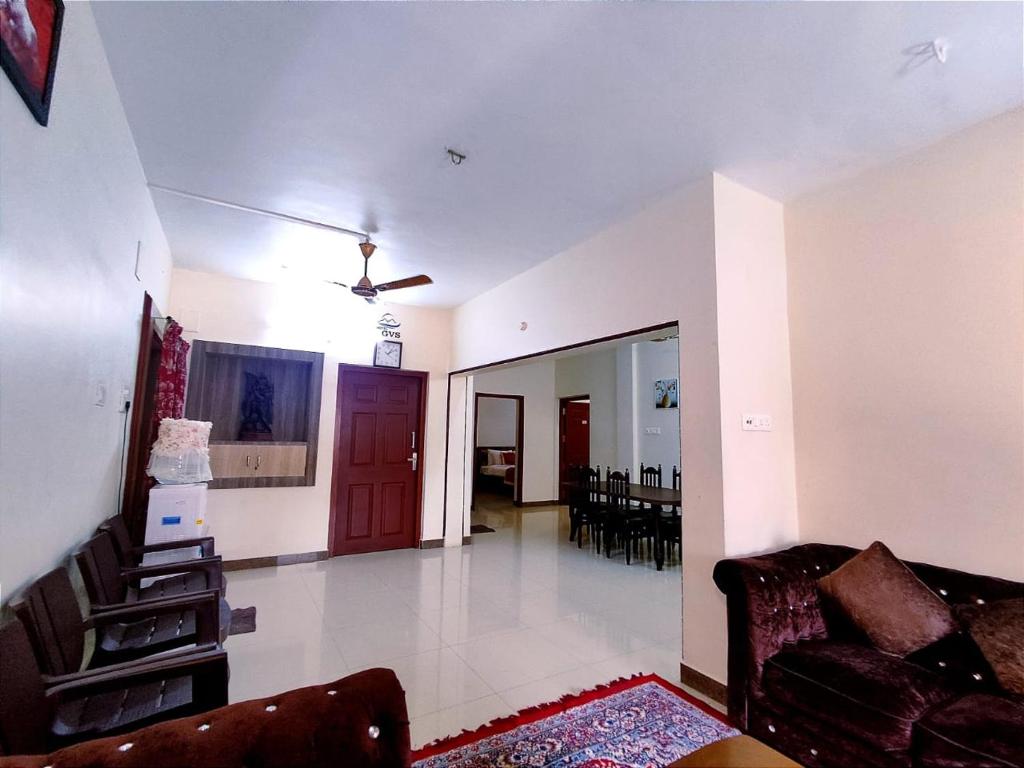 a living room with a couch and a table at Hotel GVS Residency in Yercaud