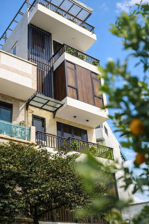 a tall building with balconies on the side of it at Mèn Mén Home in Phú Thọ