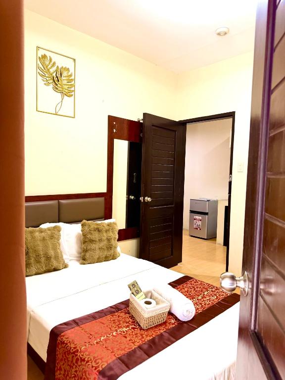 a hotel room with a bed and a door with a basket at Isla Boracay Inn in Boracay