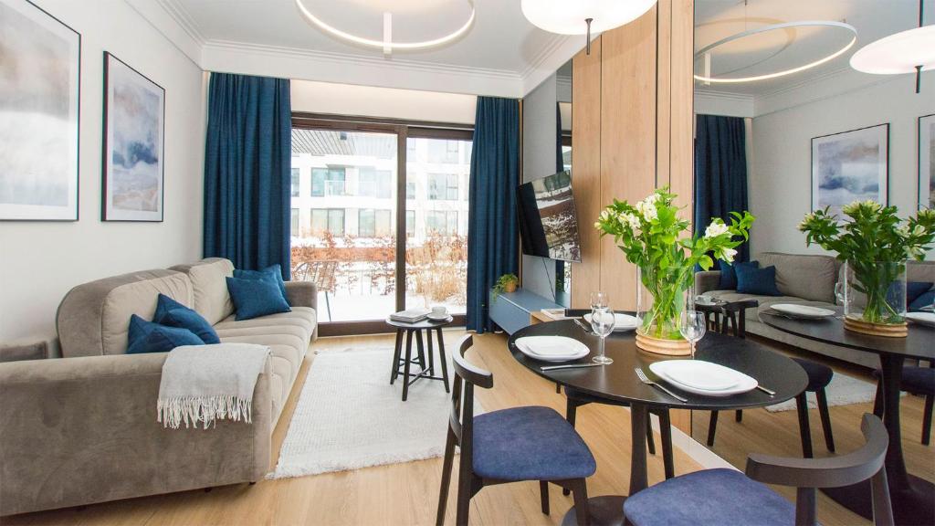 a living room with a couch and a table at Sol Marina - Lazur in Wiślinka
