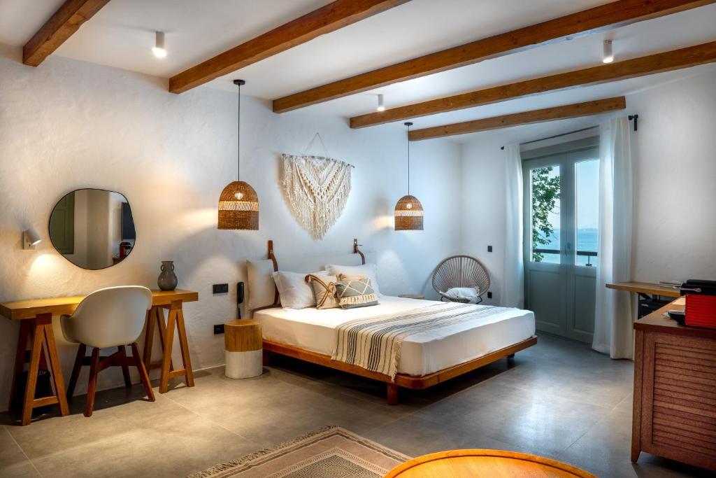a bedroom with a bed and a desk and a mirror at Carpe Diem Boutique Hotel - Adults Only in Side