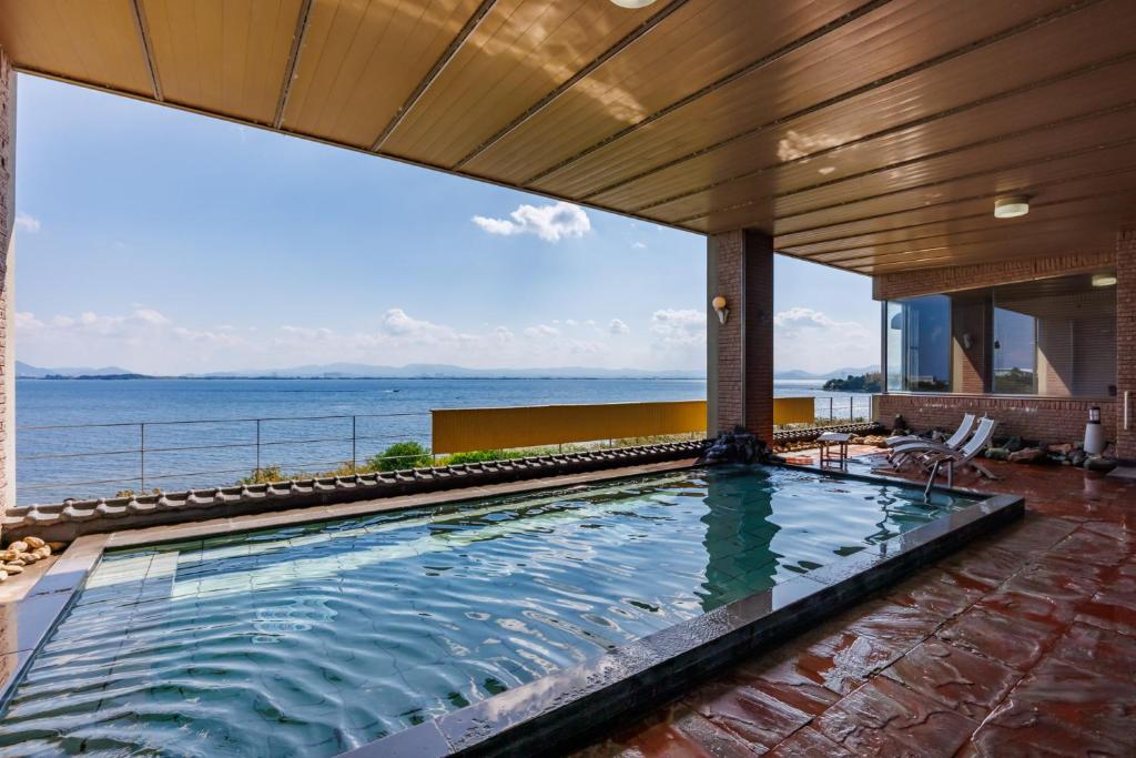 a swimming pool with a view of the ocean at Biwako Grand Hotel Kyo-Ohmi in Otsu