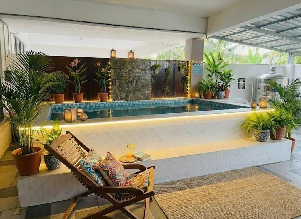 a pool in the middle of a patio with chairs and plants at Sulong Inn - Private Pool Homestay in Kuantan, Pantai Sepat in Kuantan