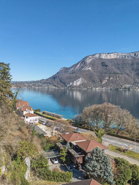 a view of a body of water with a mountain at La Roche & Le Lac in Sévrier