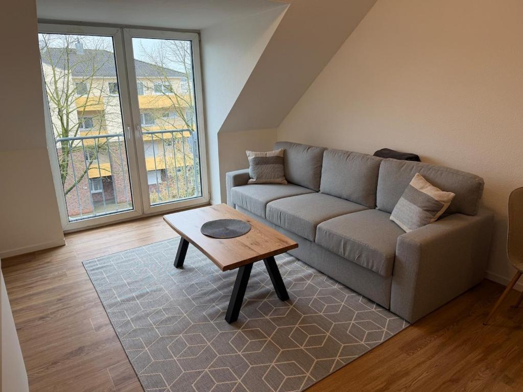 a living room with a couch and a coffee table at Stadtwohnung Bocholt in Bocholt