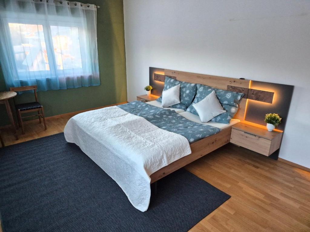 a bedroom with a large bed in a room at Gästezimmer Mürztal in Langenwang Schwöbing