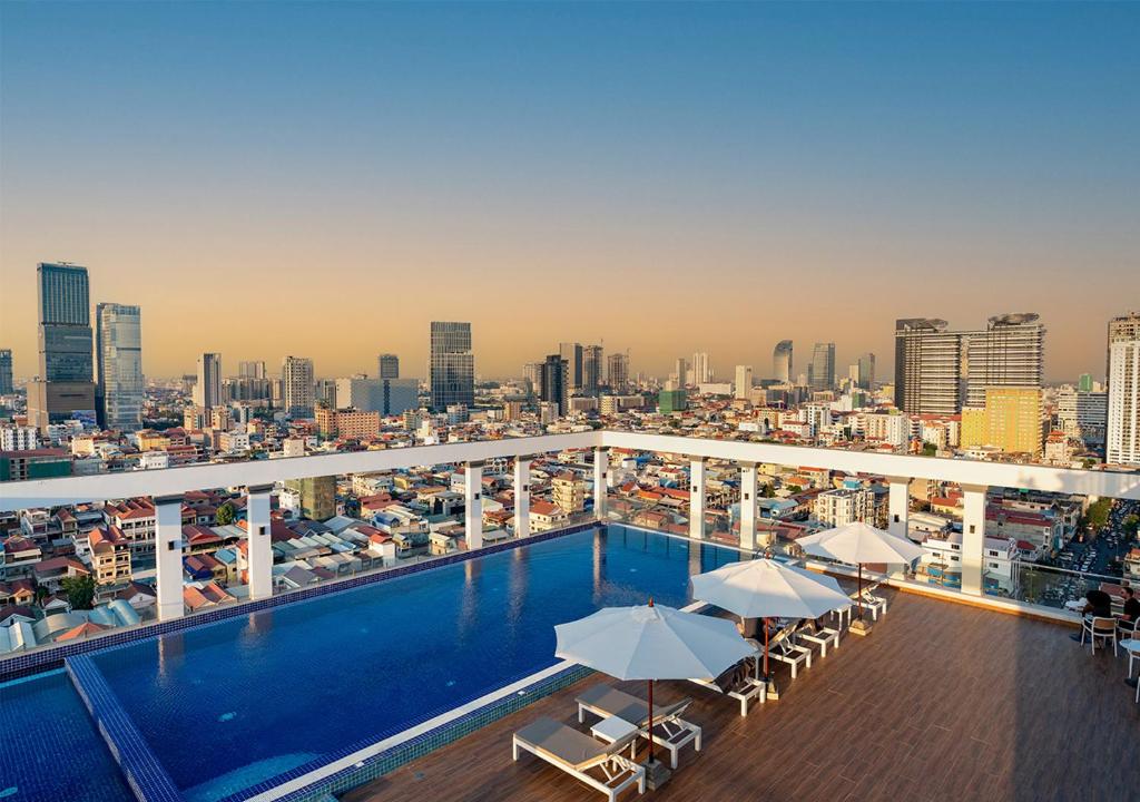 a swimming pool on top of a building with a city at LN Hotel & Residence in Phnom Penh