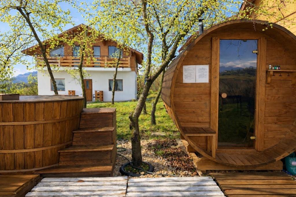 a wooden sauna in front of a house at Ammon Mountain Villas in Bran