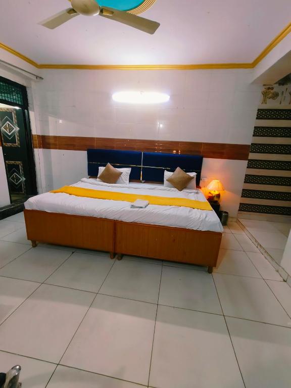 a bedroom with a bed in a room with a ceiling at S D palace in Dighori