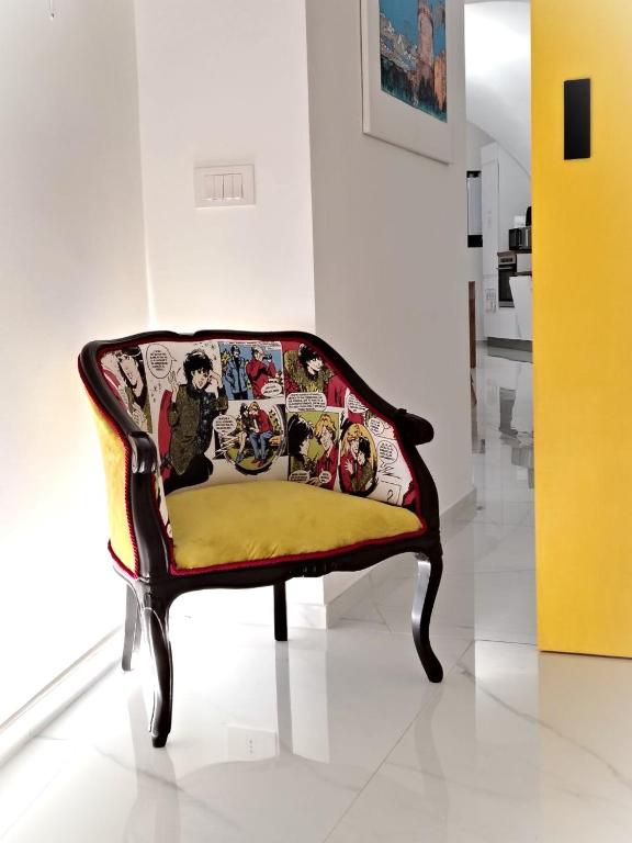 a couch sitting in a room with a yellow cushion at LianHome b&b "Volte" in Lucera