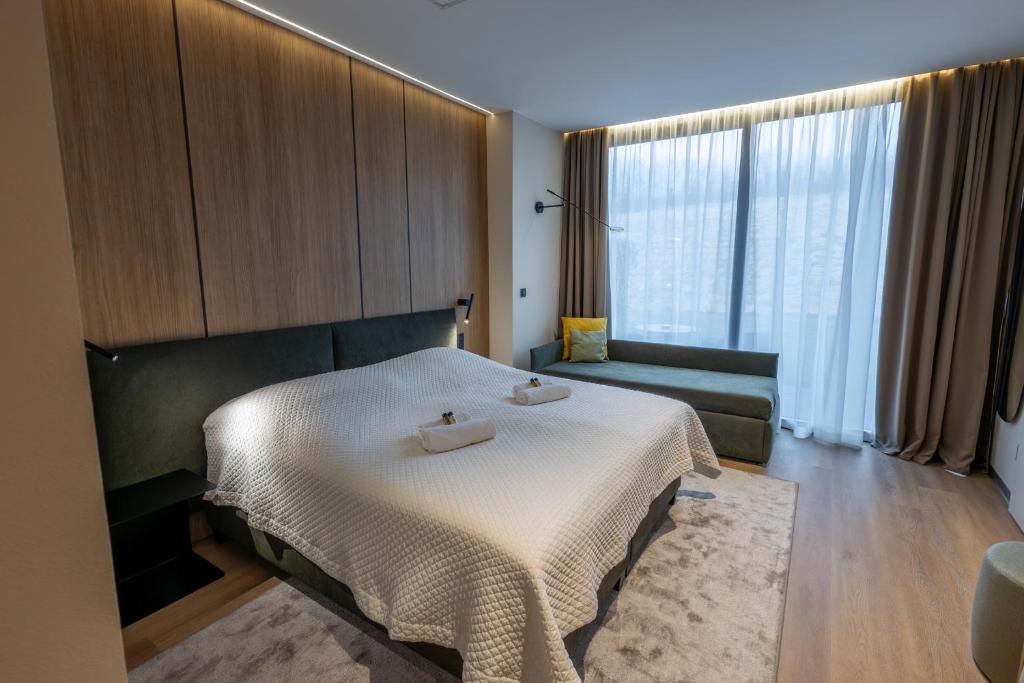 a hotel room with a bed and a couch at Lajvér Borbirtok in Szálka