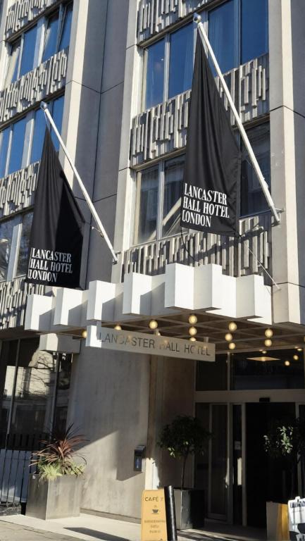 a building with signs on the front of it at Lancaster Hall Hotel in London