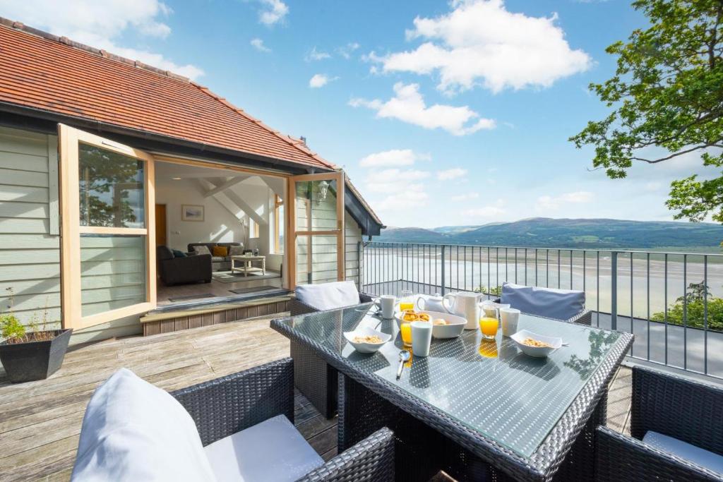 a patio with a table and chairs on a deck at 2 Bed in Aberdyfi oc-wah694 in Aberdyfi