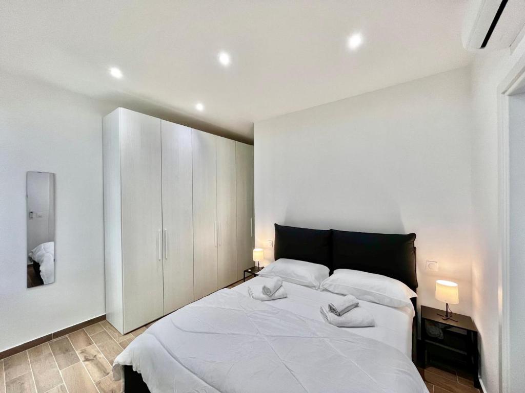 a bedroom with a large bed with two towels on it at Comfortable 1-Bedroom Central Menton in Menton