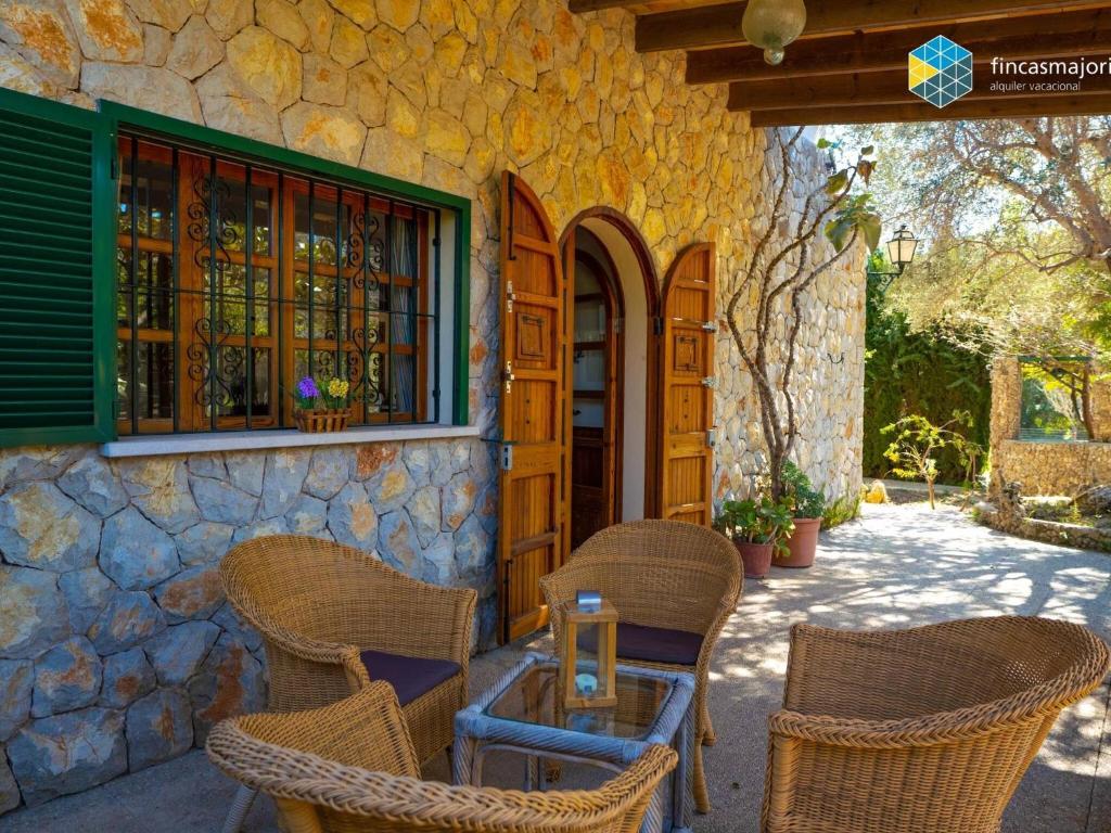 a patio with chairs and a table in front of a building at Can Moreu in Caimari