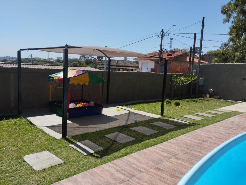 a play structure with a canopy in a yard at Chacrinha in Campinas