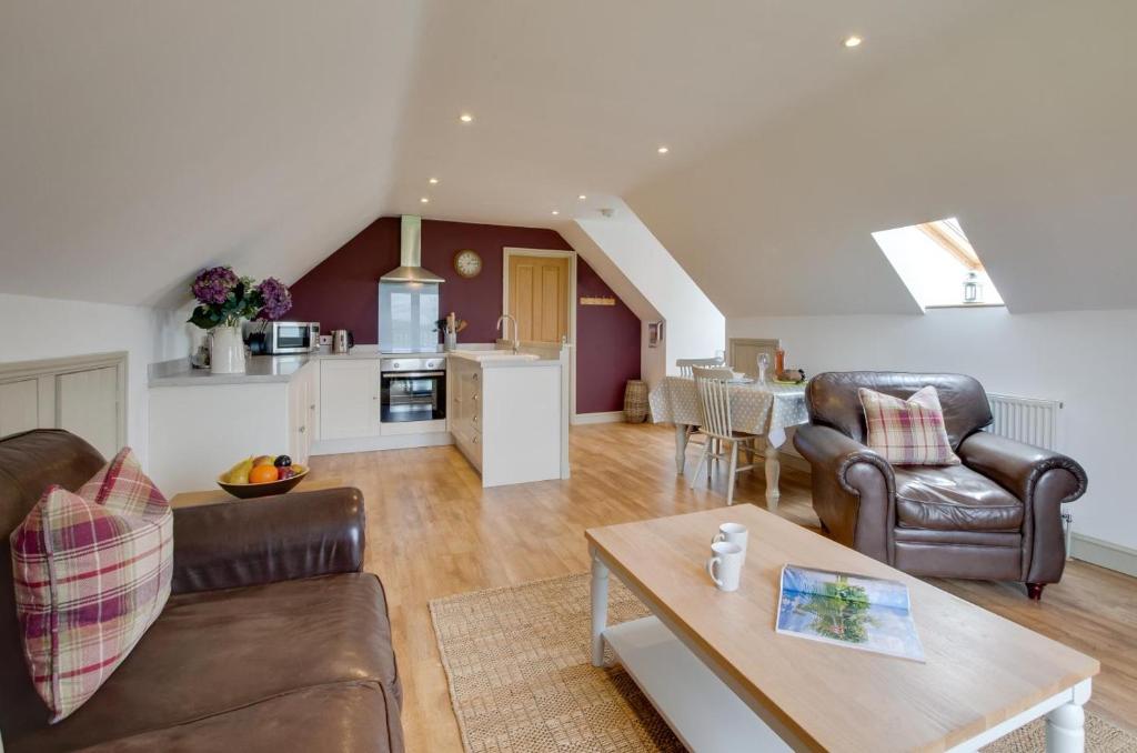 a living room with a couch and a table at 1 Bed in Swannington oc-2206 in Attlebridge