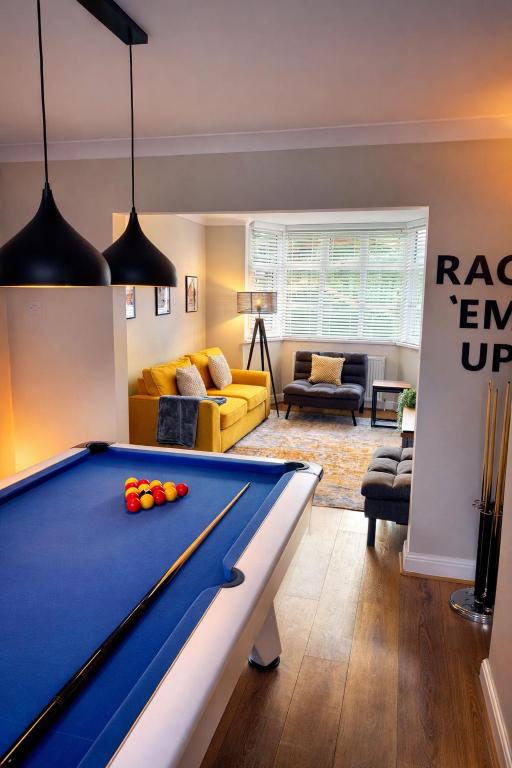 a billiard room with a pool table and a living room at Parkfield House in Smethwick