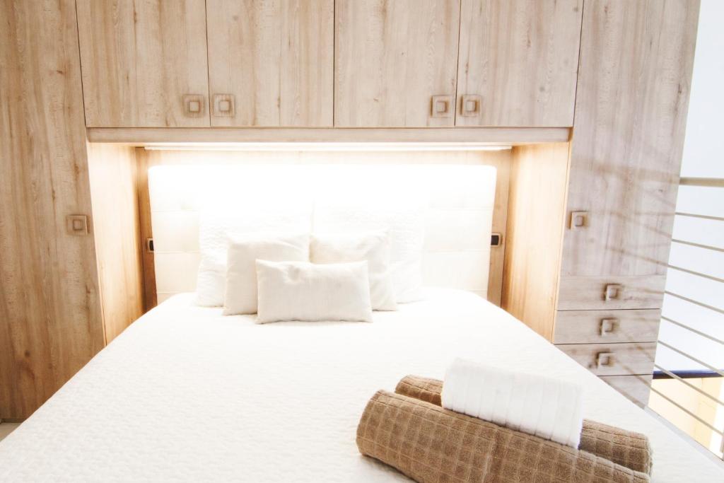 1 dormitorio con 1 cama grande con almohadas blancas en Alessia's Flat - Portello, en Milán