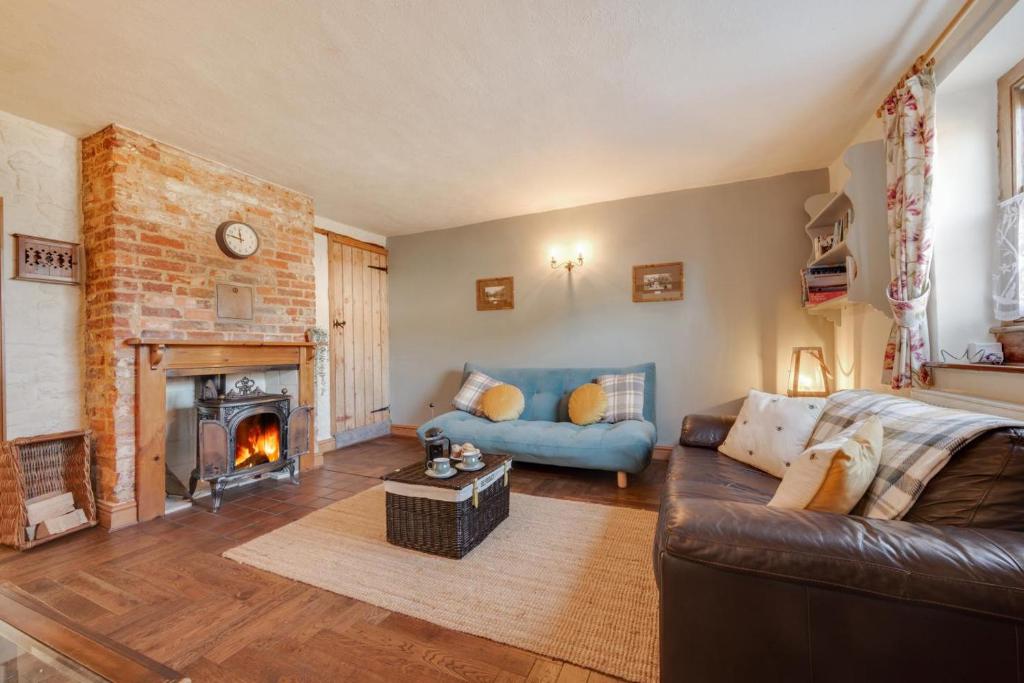 a living room with a couch and a fireplace at 2 Bed in Heacham oc-2365 in Heacham