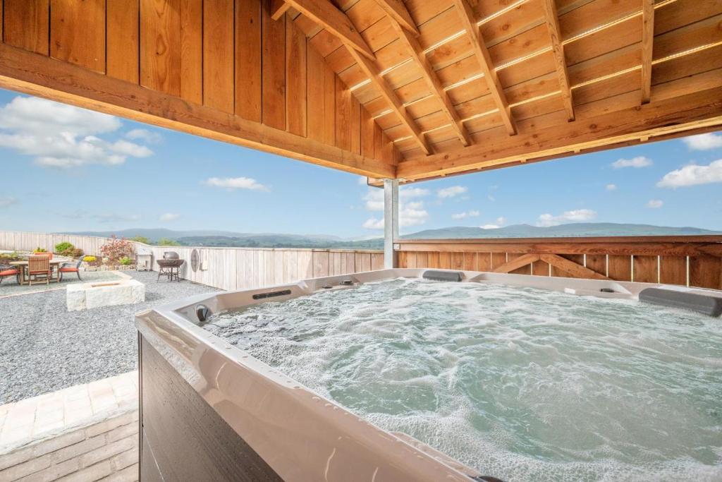 a hot tub on the deck of a house at 3 Bed in Trawsfynydd oc-wag718 in Trawsfynydd