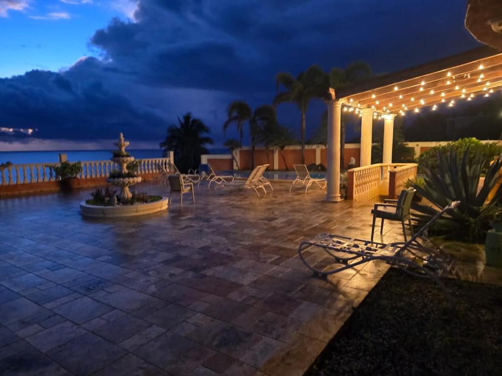 a patio with chairs and lights at night at Exotic Paradise Guest House in Yabucoa