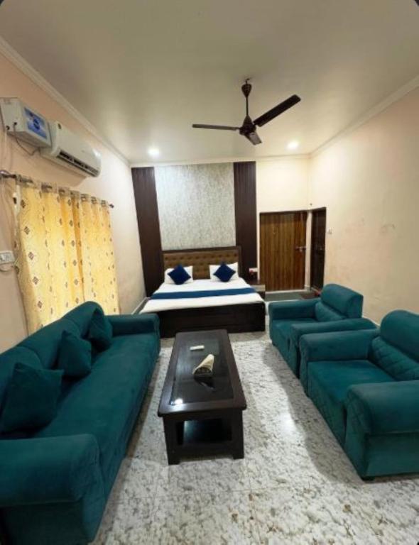 a living room with a couch and a bed at Hotel Indra Palace Jaunpur in Jaunpur