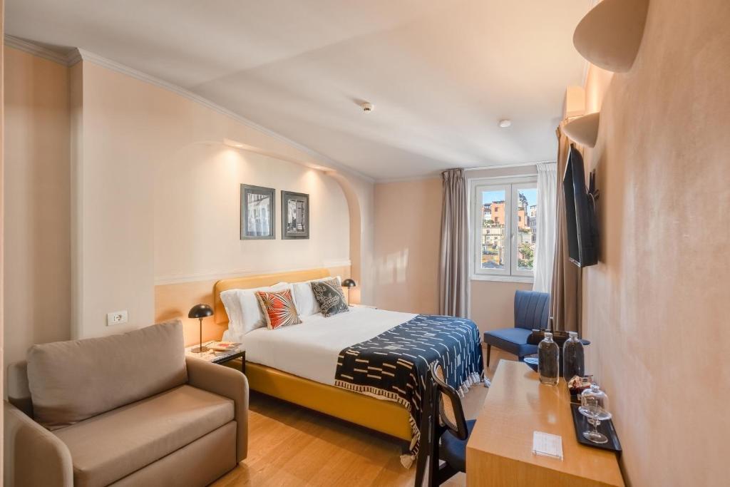 a hotel room with a bed and a chair at The Couper Piazza di Spagna in Rome