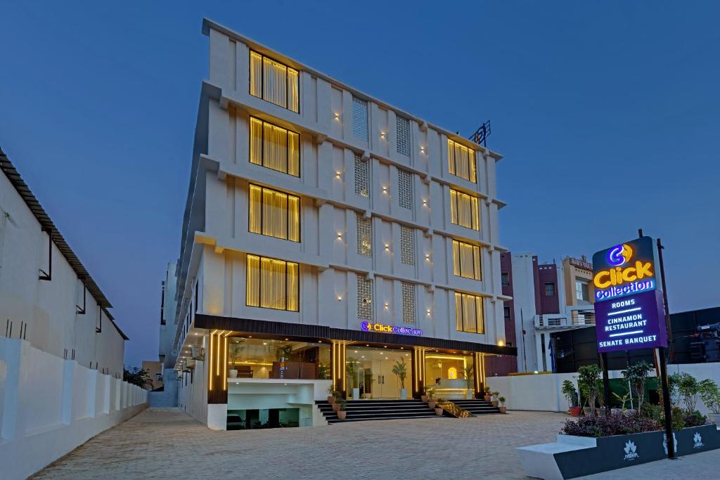 a hotel building with a sign in front of it at Click Collection Ayodhya in Ayodhya