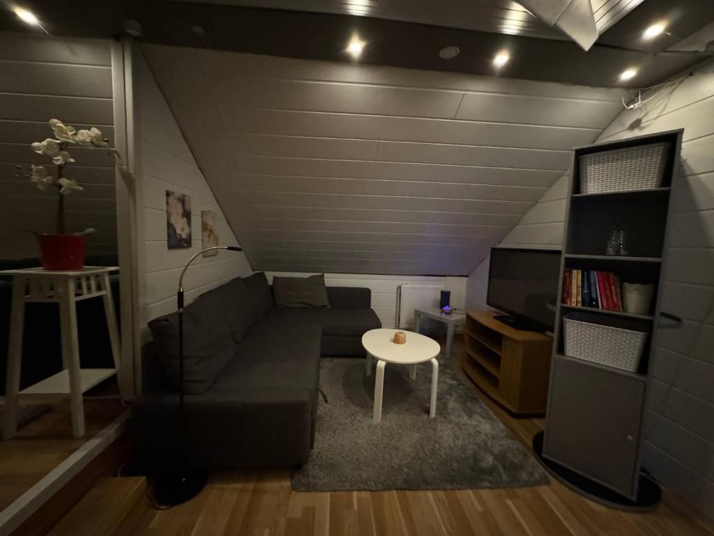 a living room with a couch and a table at Apartment Bjarmaland in Vestmannaeyjar