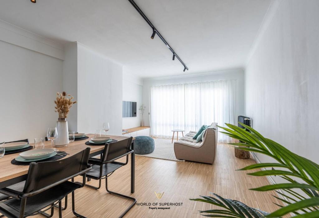 a living room with a table and chairs and a couch at Luxurious apartment next to the sea and city centre with free parking space in Ostend