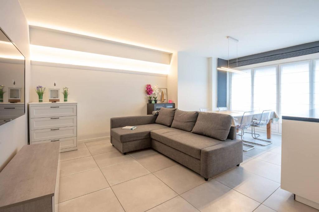 a living room with a couch and a table at Amazing apartment for 8 with parking space in Ostend