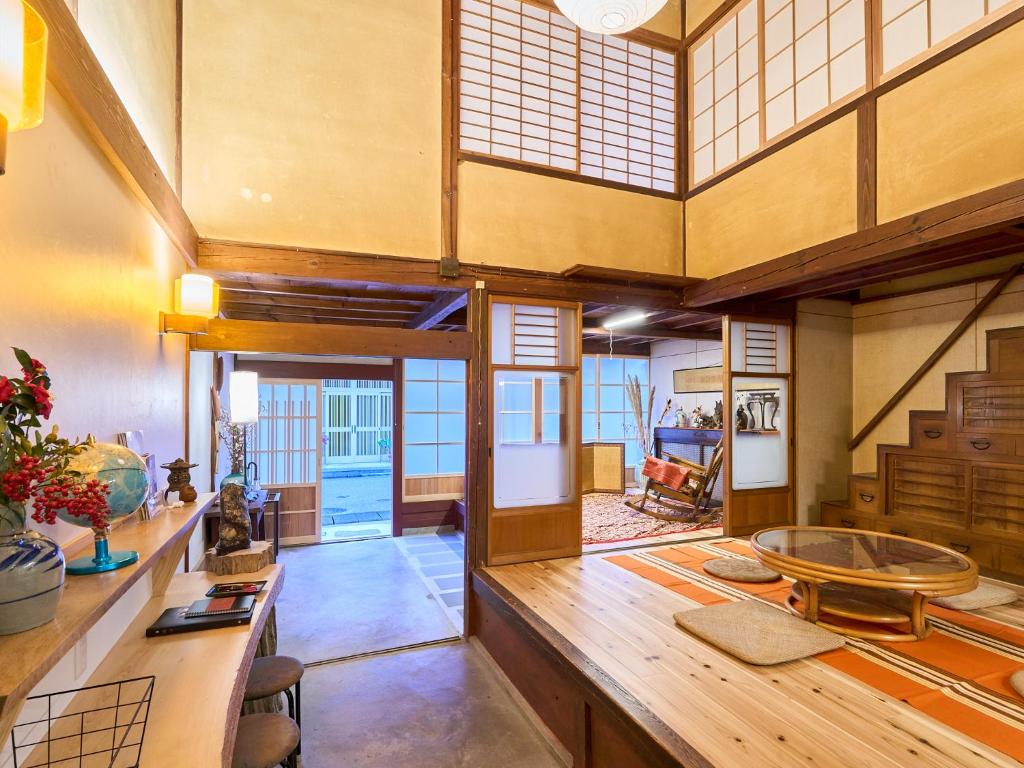 a large room with a large wooden table at The Cross Inn Gujo in Gujo