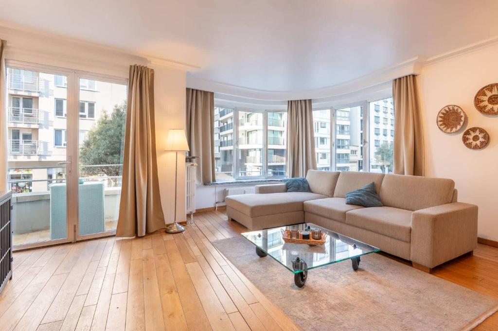 a living room with a couch and a table at Appartement Montfleuri in Ostend